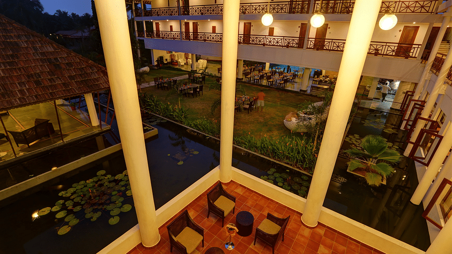 Seating area supported by white pillars - Rhythm Kumarakom