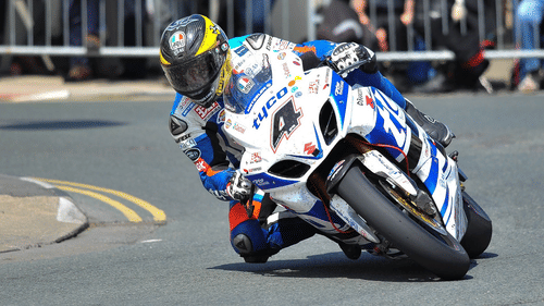 A person racing on a motorbike