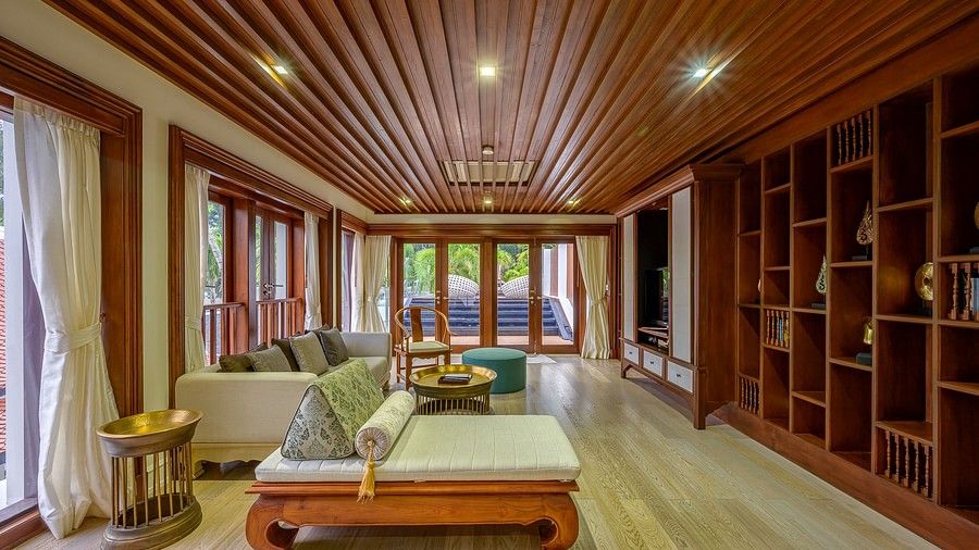 full view image of the living area with full length windows at the far end of the room - three bedroom private pool villa