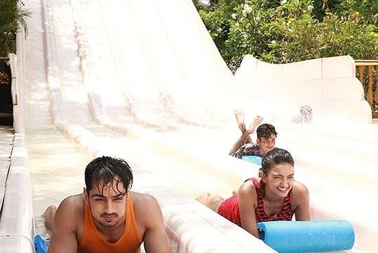 Water Kingdom - 3 people at the end of a water slide at our water park