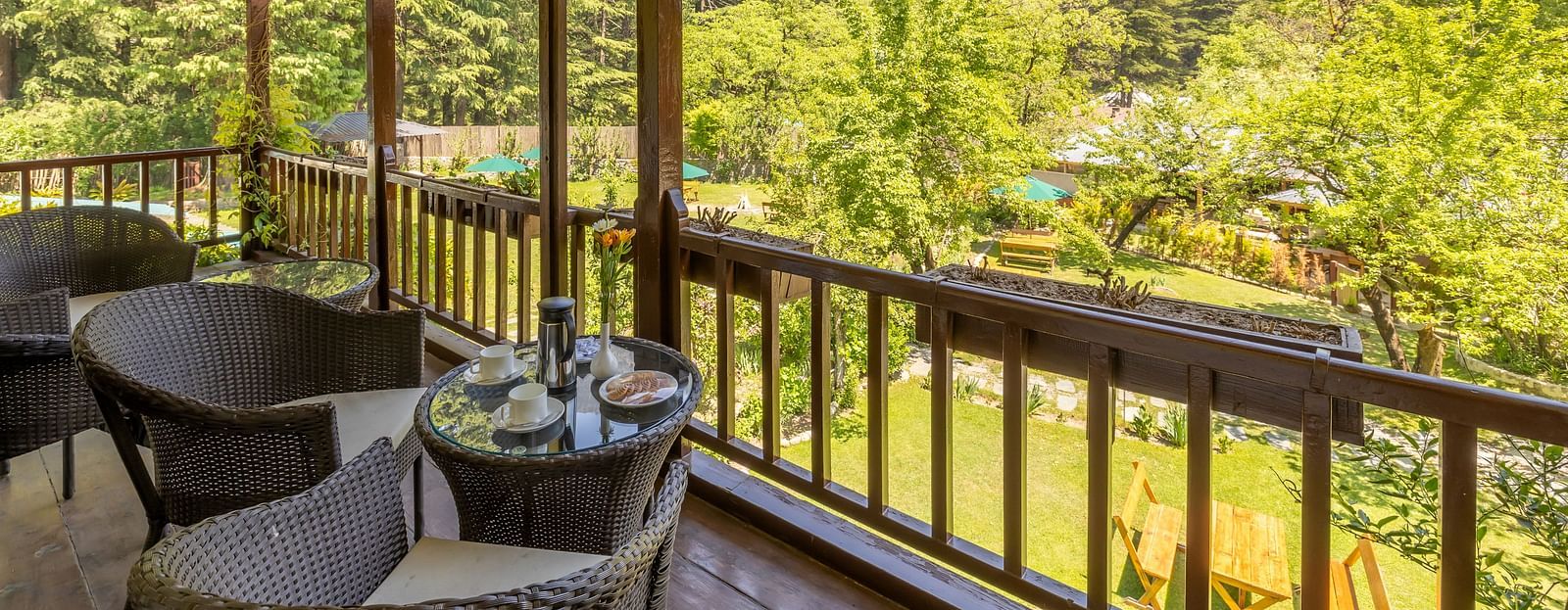 view through the balcony with seating area at Bedzz Xclusive Baikunth,Manali