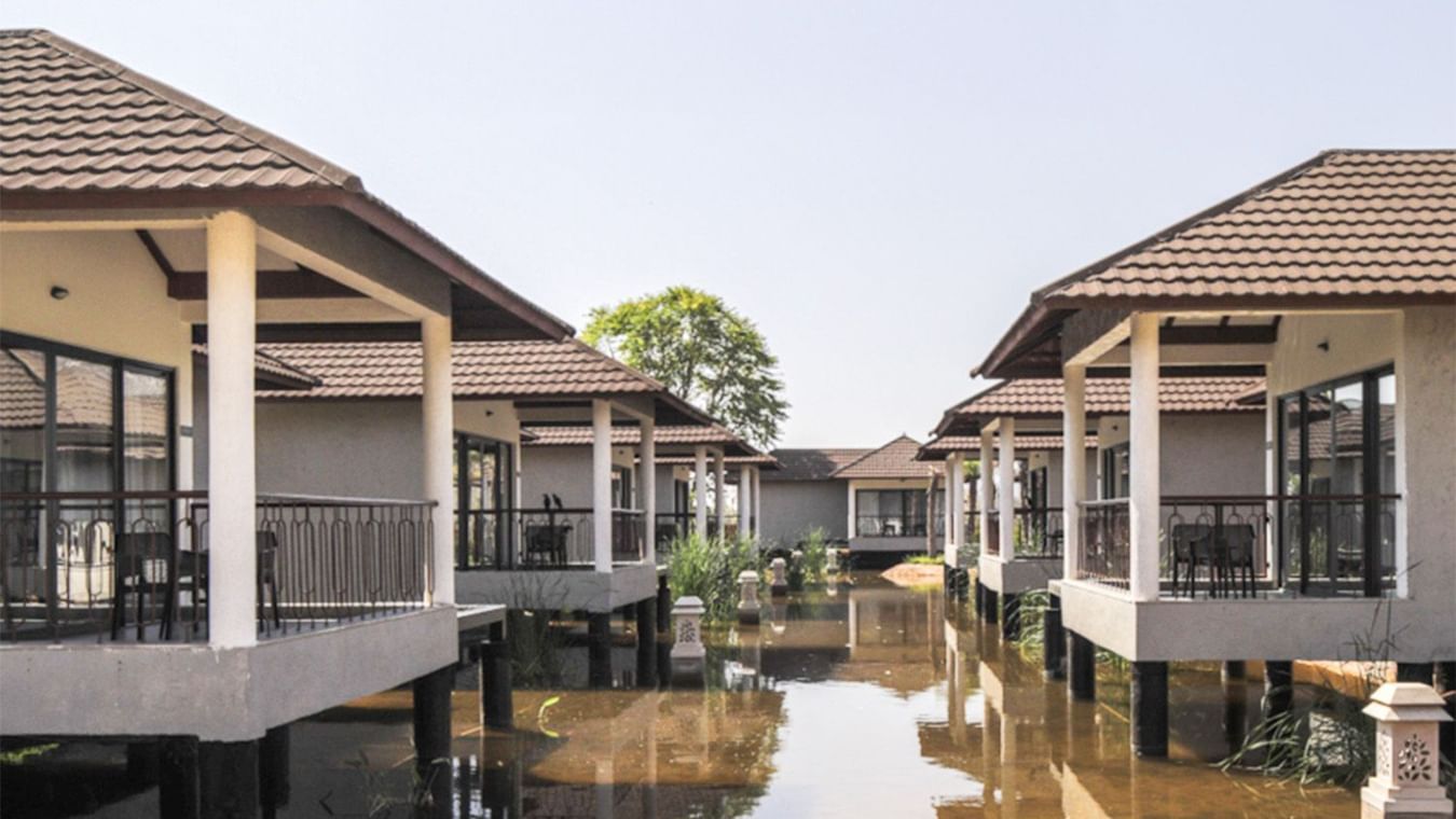 External view of Lagoon Villas at Ananta Spa & Resort, Ajabgarh, on both sides standing on pillars in a pool of water.