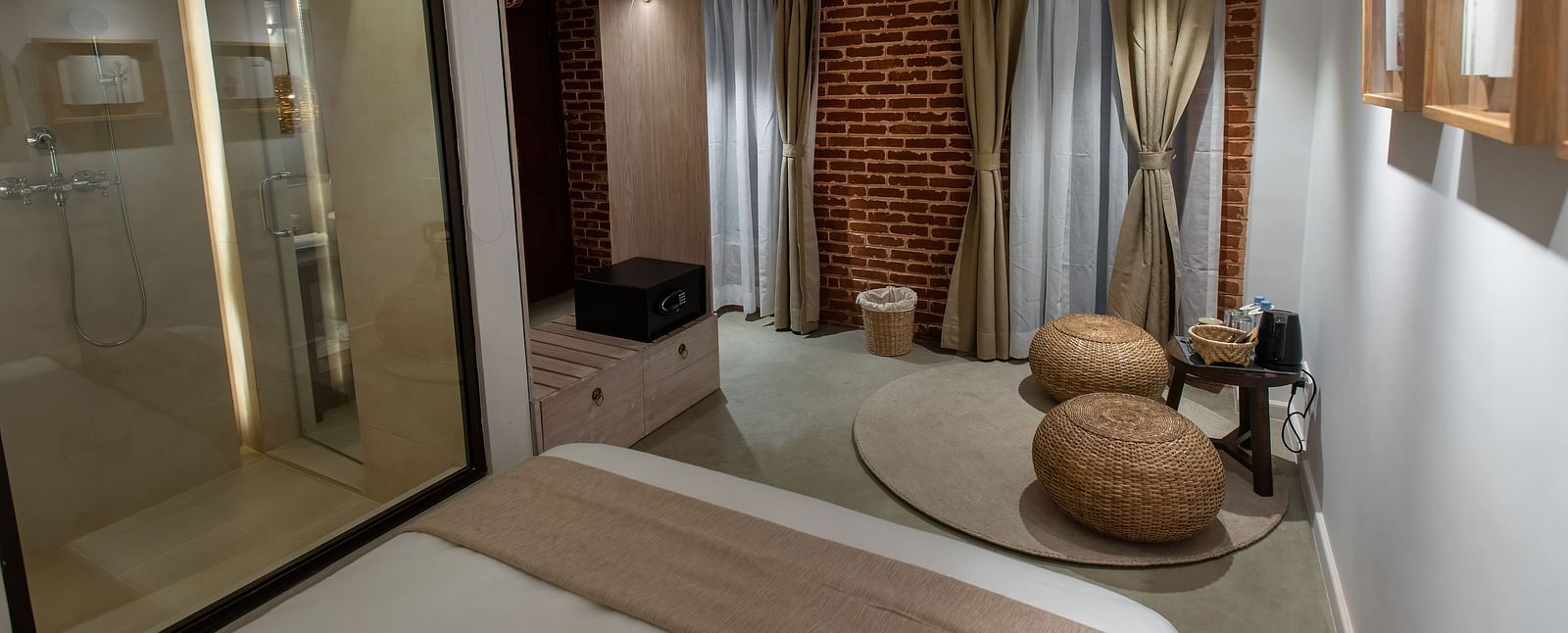 Standard room with bed, bamboo tools and a away leading to the washroom - The Nanee 
