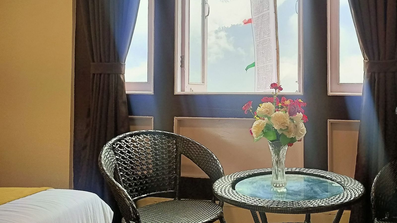 Deluxe Room at Ecotel Sonam Lachung decked with a chair and tea table