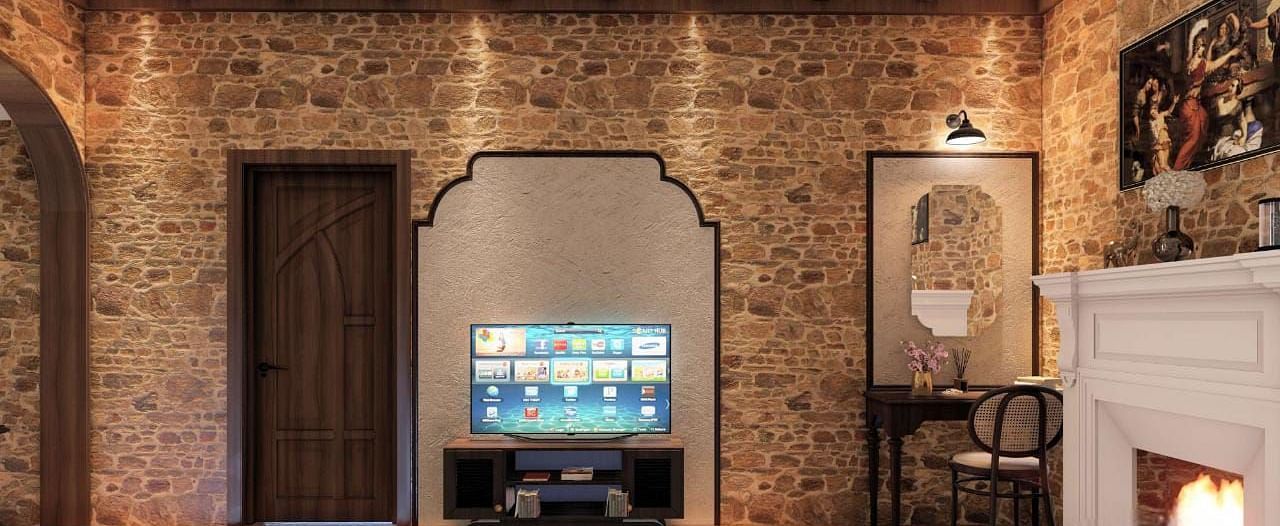 A rustic room features stone walls, a flat-screen TV, and an ornate mirror above a fireplace, beside a comfortable bed - BluSalzz Escapade Resort, Dalhousie 