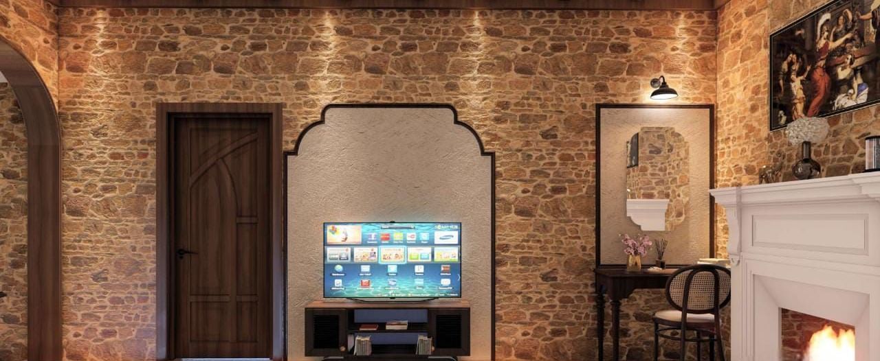 Rustic bedroom featuring a stone-clad wall, exposed timber beams, a fireplace, and a television recessed in an archway at BluSalzz Terrah Hills Resort, Dalhousie.