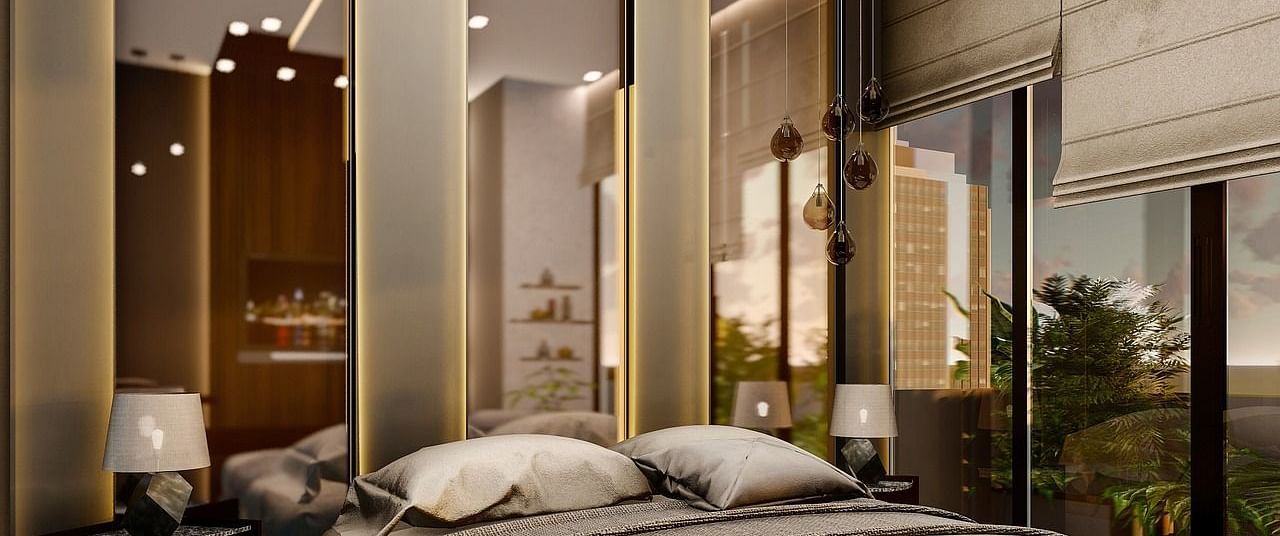 A room with chic and modern interiors with tall mirrors behind the bed.