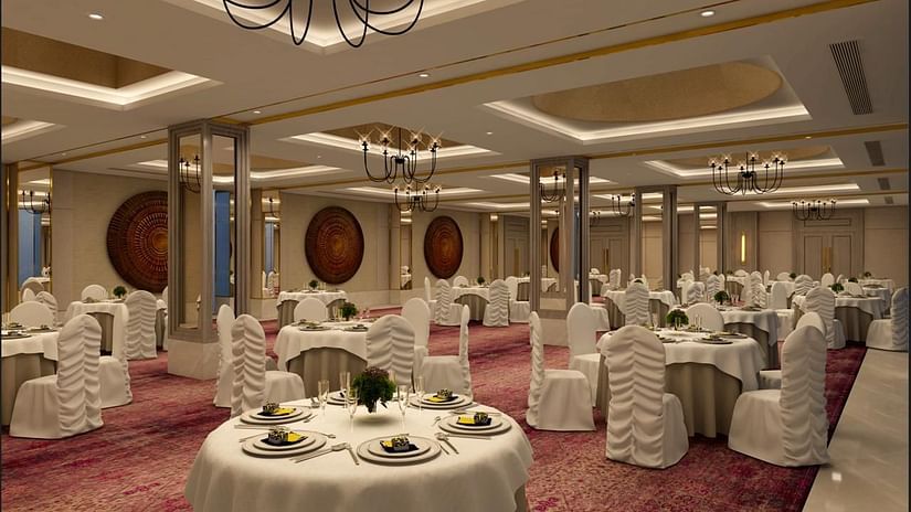 tables set up in a cluster arrangement inside Aura banquet hall at Sarovar Portico Birgunj