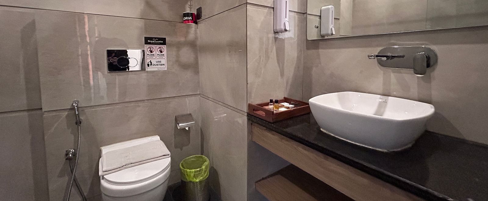 A of a washroom taken from left angle featuring a toilet seat and wash basin - DLS Grand Luxotica, Dehradun