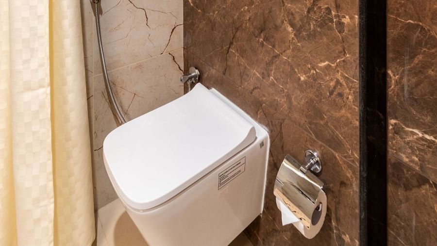 Modern shower and toilet in The Executive Rooms at Livancia The Sojourn, Bangalore.
