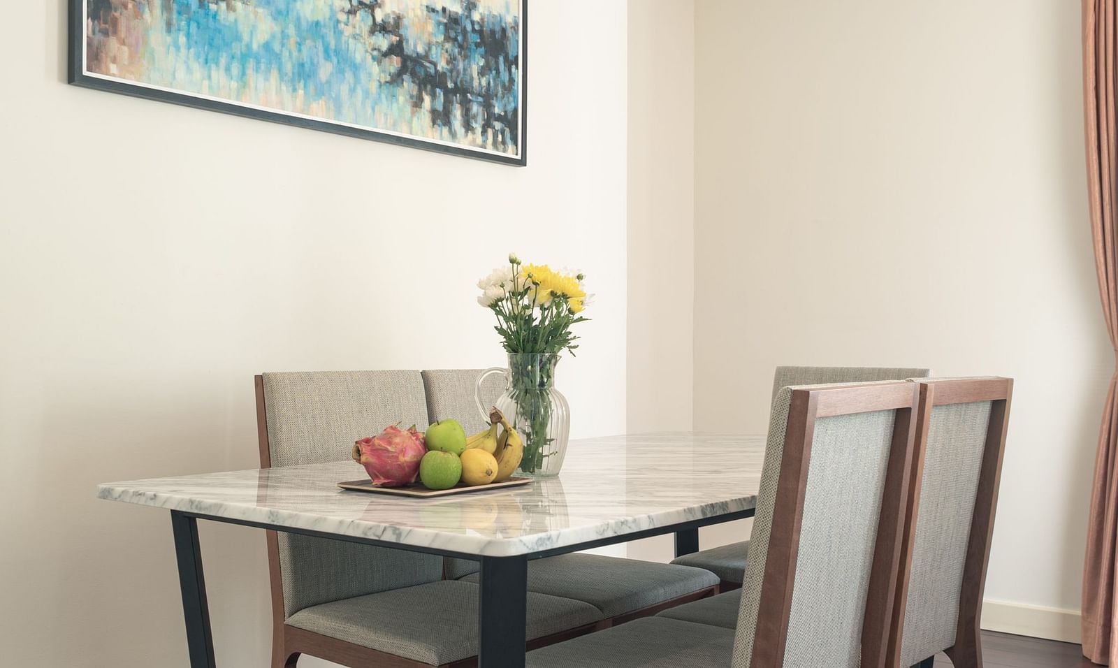 A dining area with a table, chairs, and a painting on the wall, with a window and AC | Three-bedroom Suite | Central Mansions, Phnom Penh
