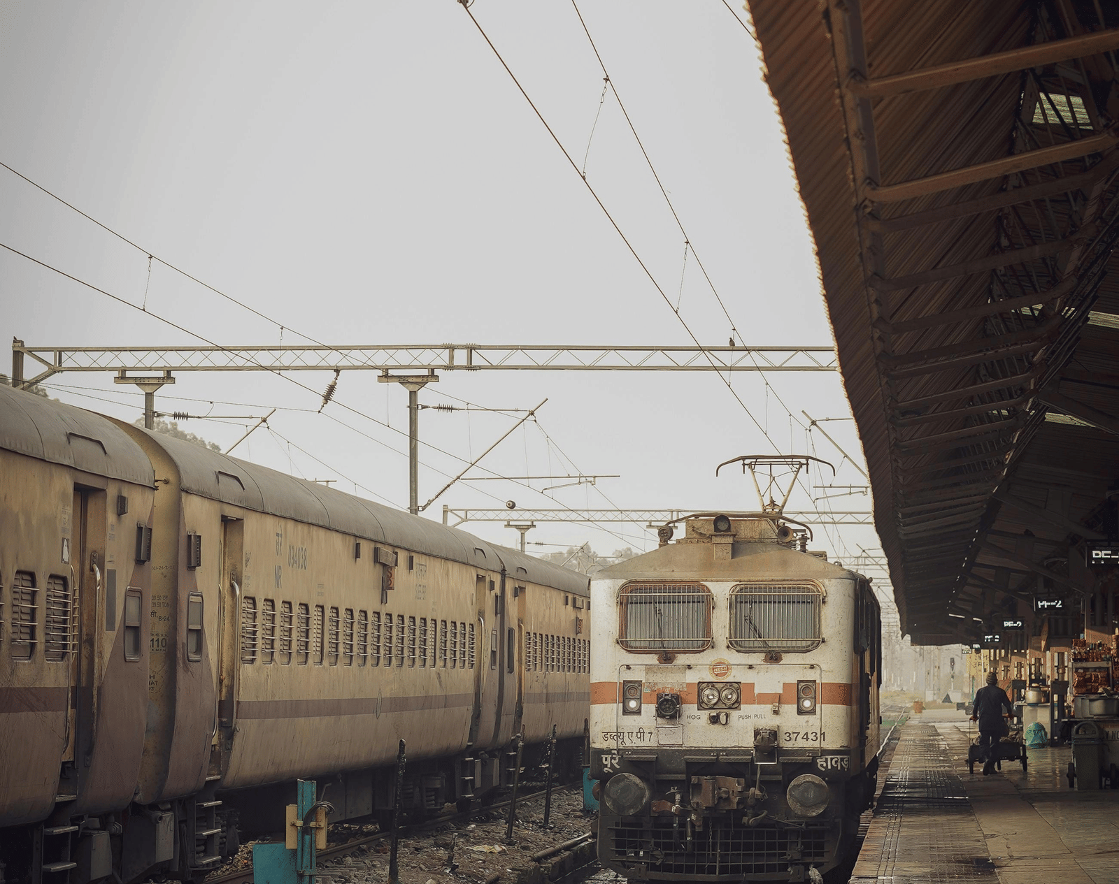 An Indian railway locomotive stationed on a platform at a railway station.