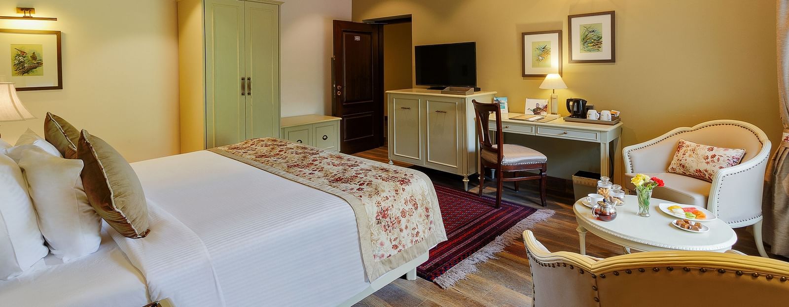 An image, featuring a side view of cosy room with comforting decors, bed, wooden ceiling - The Naini Retreat