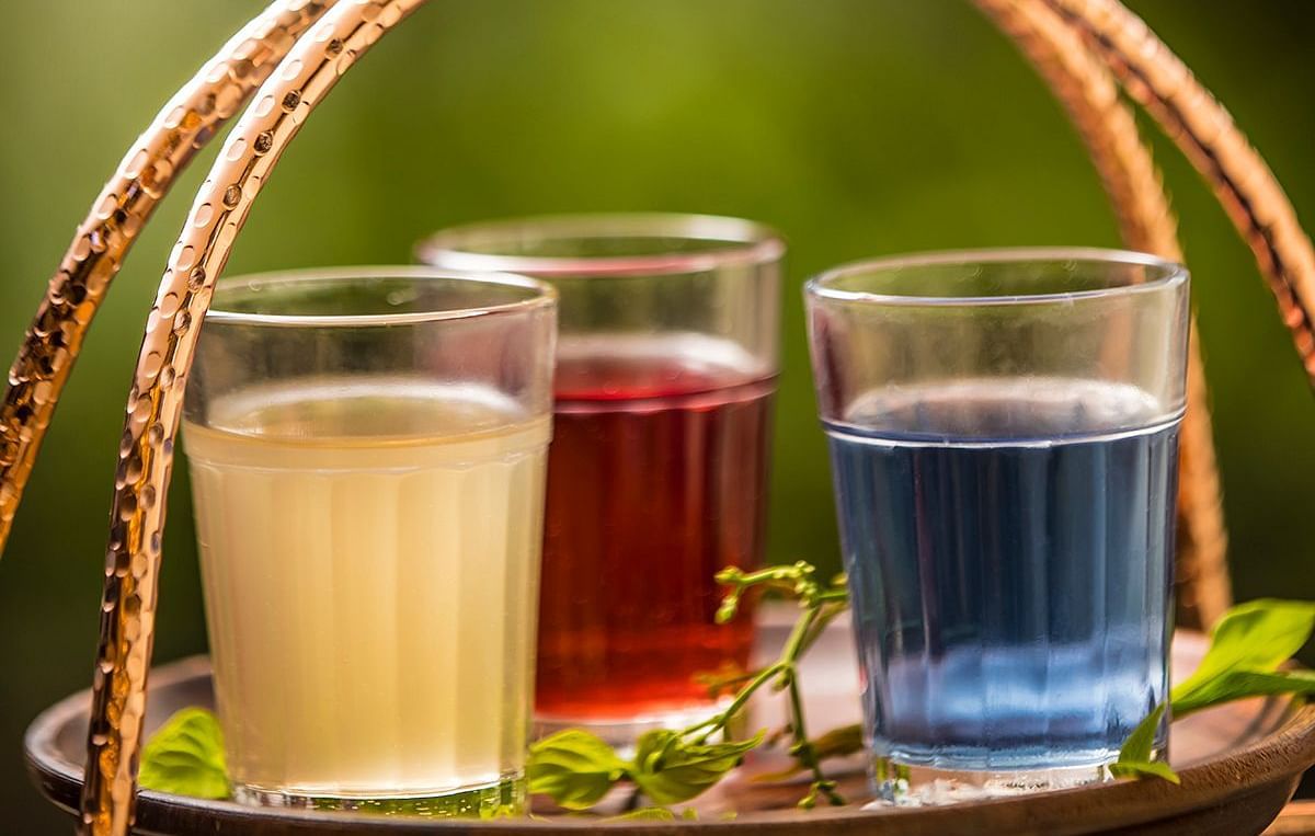 Image of different glasses with drinks kept in a basket - GReaT trails Wayanad by GRT Hotels.
