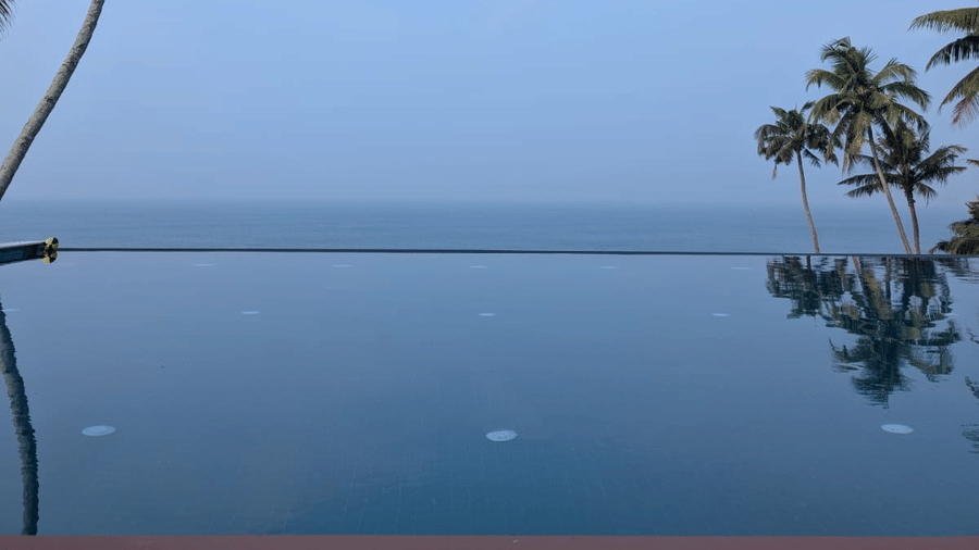 A Rooftop infinity pool at SUKAVI with the pool edge overlooking the surrounding area.
