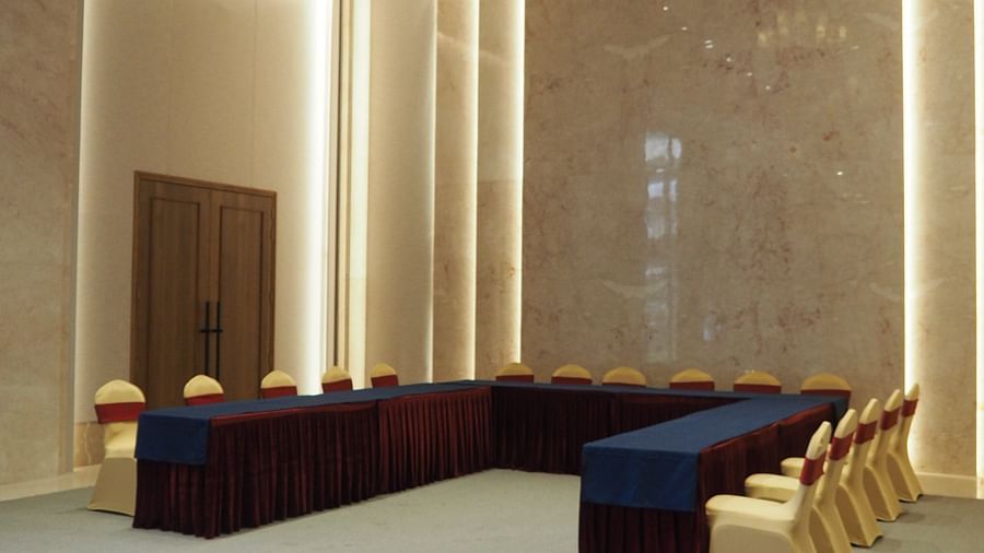 A U-shaped table arrangement in a modern, brightly lit conference space - Club Charholi, Pune 