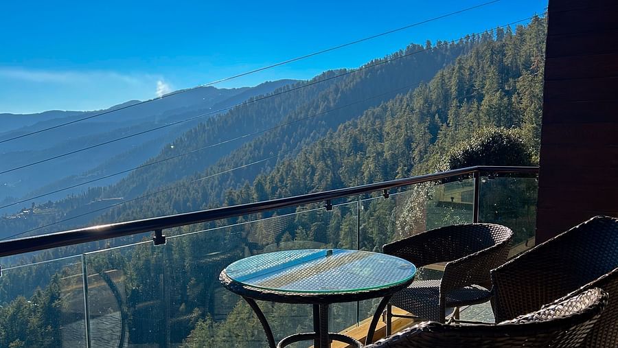 Private balcony seating at Aranya Himalayan Retreat with stunning views of the Mashobra hills and valleys