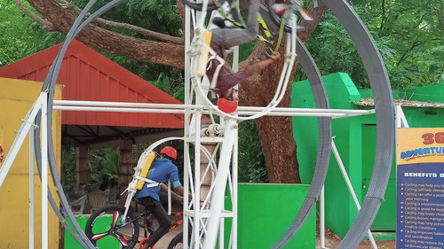 A person riding a bicycle going in a circular motion at Black Thunder, Coimbatore