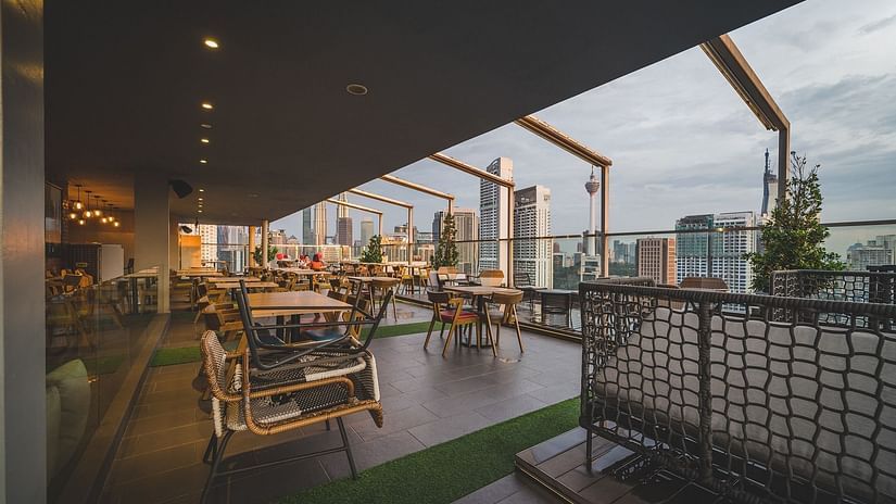 A rooftop restuarant overlooking the city views with blue sky