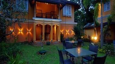 A lawn at Tea Bungalow with chairs placed around a table in the lawn