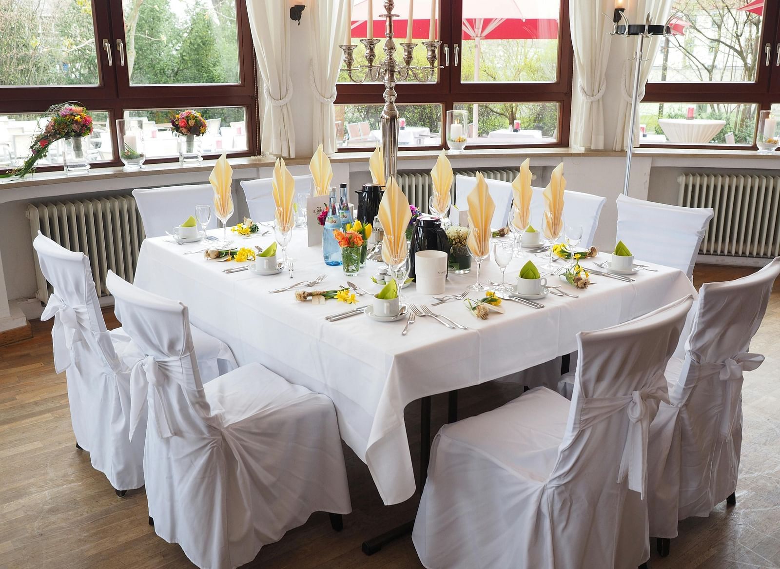 A table and chairs, elegantly decorated and arranged for an event.