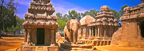 Multiple rock-cut temples with carved figures and an elephant sculpture near Hotel Mamallaa Heritage, Mahabalipuram.