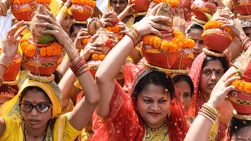 A procession of a huge number of women, dressed in traditional attire.