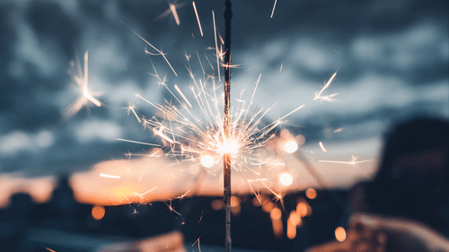 Women holding fire sparkles 