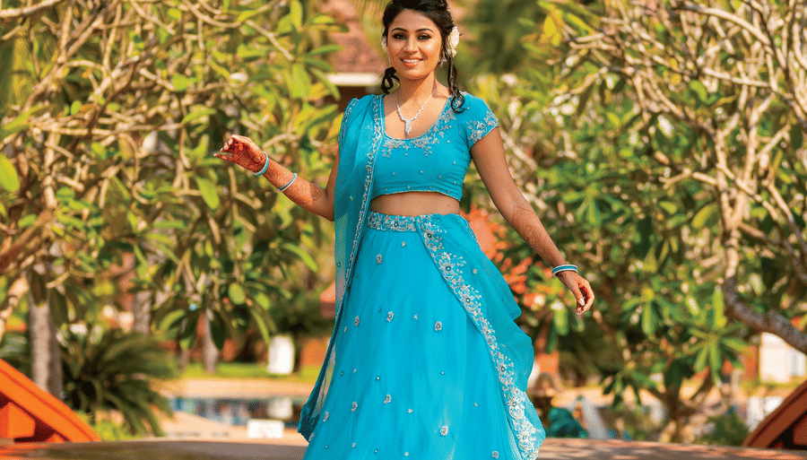 a woman posing for a picture with greenery in the background - Caravela Beach Resort Goa