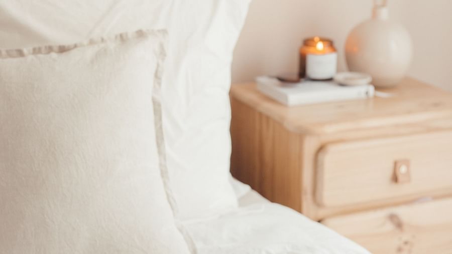 A serving tray with food on top of a bed