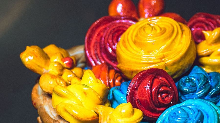 A basket filled with an assortment of colorful artificial flowers.
