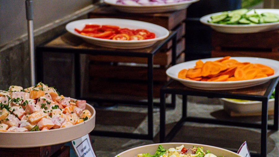 A buffet setup with different food items in serving dishes.