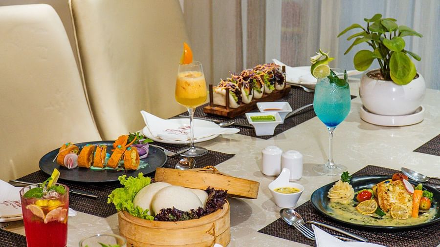 A dining table with various dishes arranged for a meal.
