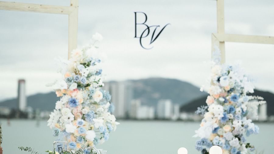 An wedding altar with a glass wall beautifully decorated by flowers - Alibu Resorts Nha Trang