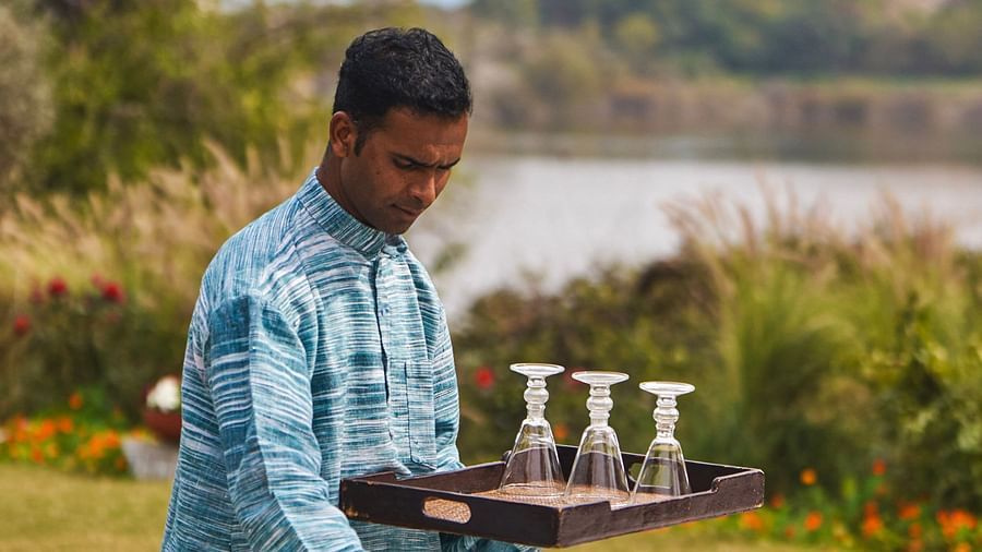 image of a person setting up the table at dev shree deogarh