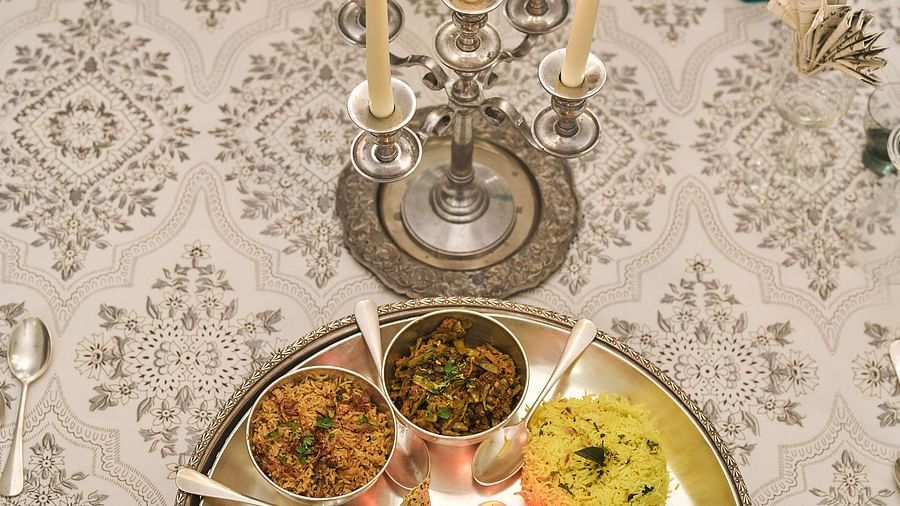 image of a traditional rajasthani thali with a candle stand in front of it at dev shree, deogarh