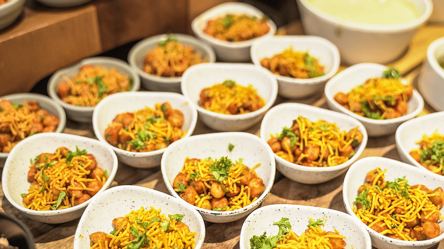 Bowls of spiced chickpeas topped with crunchy noodles, garnished with fresh coriander -  Shervani Pebbles & Pines, Corbett