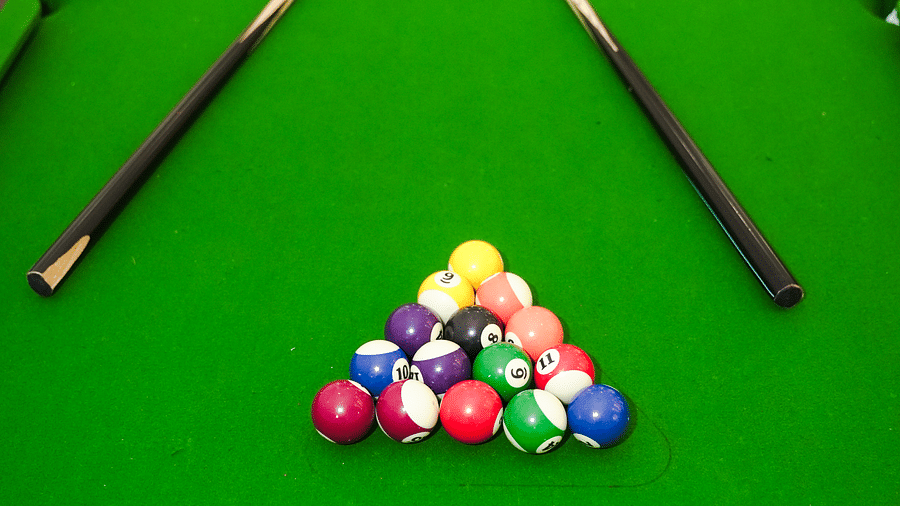 Snooker table with a triangle of coloured balls, cue sticks placed beside it - Shervani Pebbles & Pines, Corbett