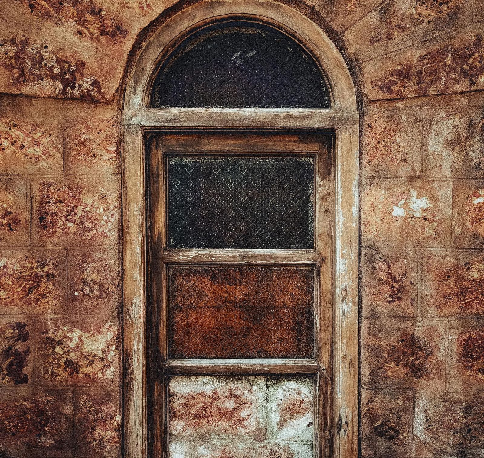 A vintage motel window on an old wall.