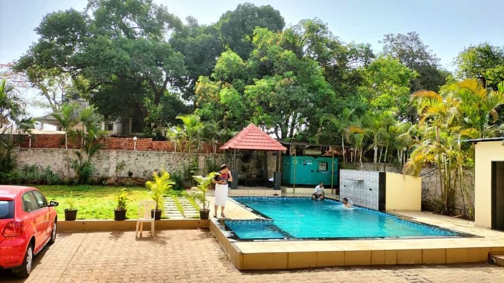 Clear outdoor swimming pool with gazebo at Mountview Resort, on a sunny day.