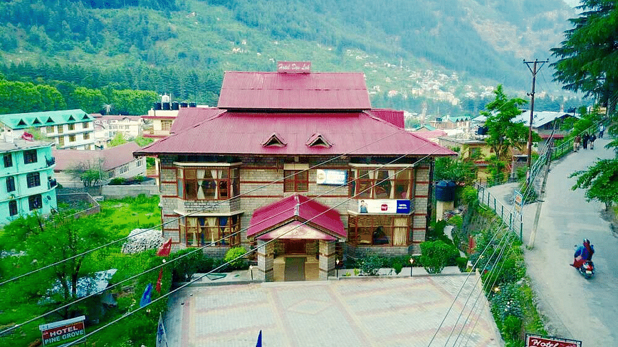 A sub-aerial view of the exterior of DLS Hotel Devlok, Manali with the mountains in the backdrop