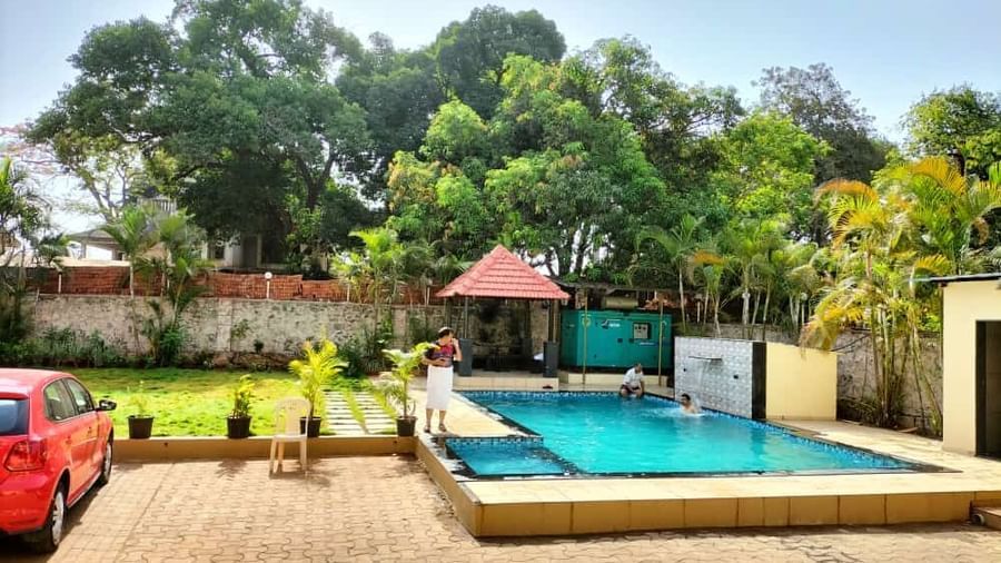 Clear outdoor swimming pool with gazebo at Mountview Resort, on a sunny day.
