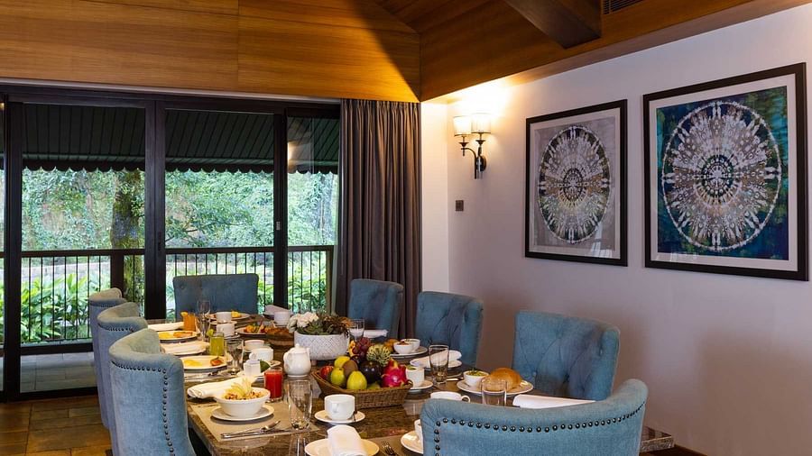dining room with blue chairs at Golak by Denissons Presidential Villa, Madikeri
