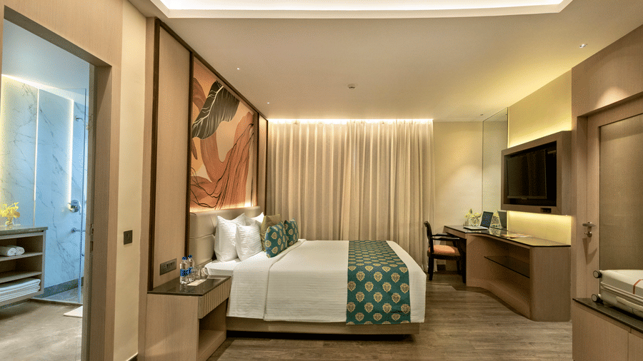 Well designed guest room with king bed, work desk and soft ambient lighting at The Sonnet, Jamshedpur.