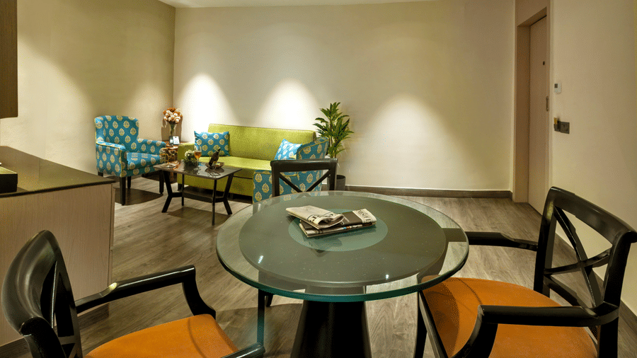 In room dining area with round table and chairs at The Sonnet, Jamshedpur.