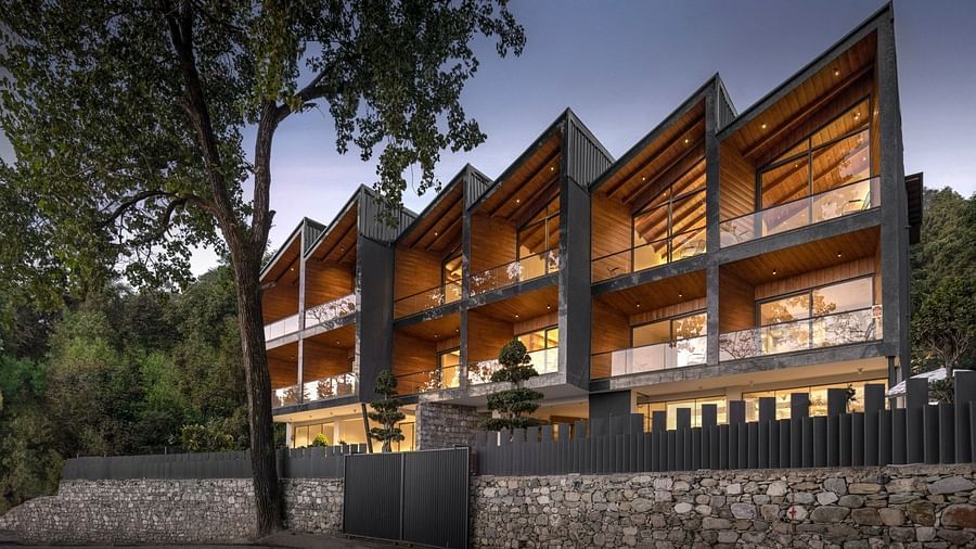 A facade image of the hotel covered in lush greenery - The Samai, Bhimtal