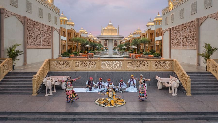 Two women performing the traditional rajasthani dance with musician playing instruments behind them - Kaldan Samudhra Palace