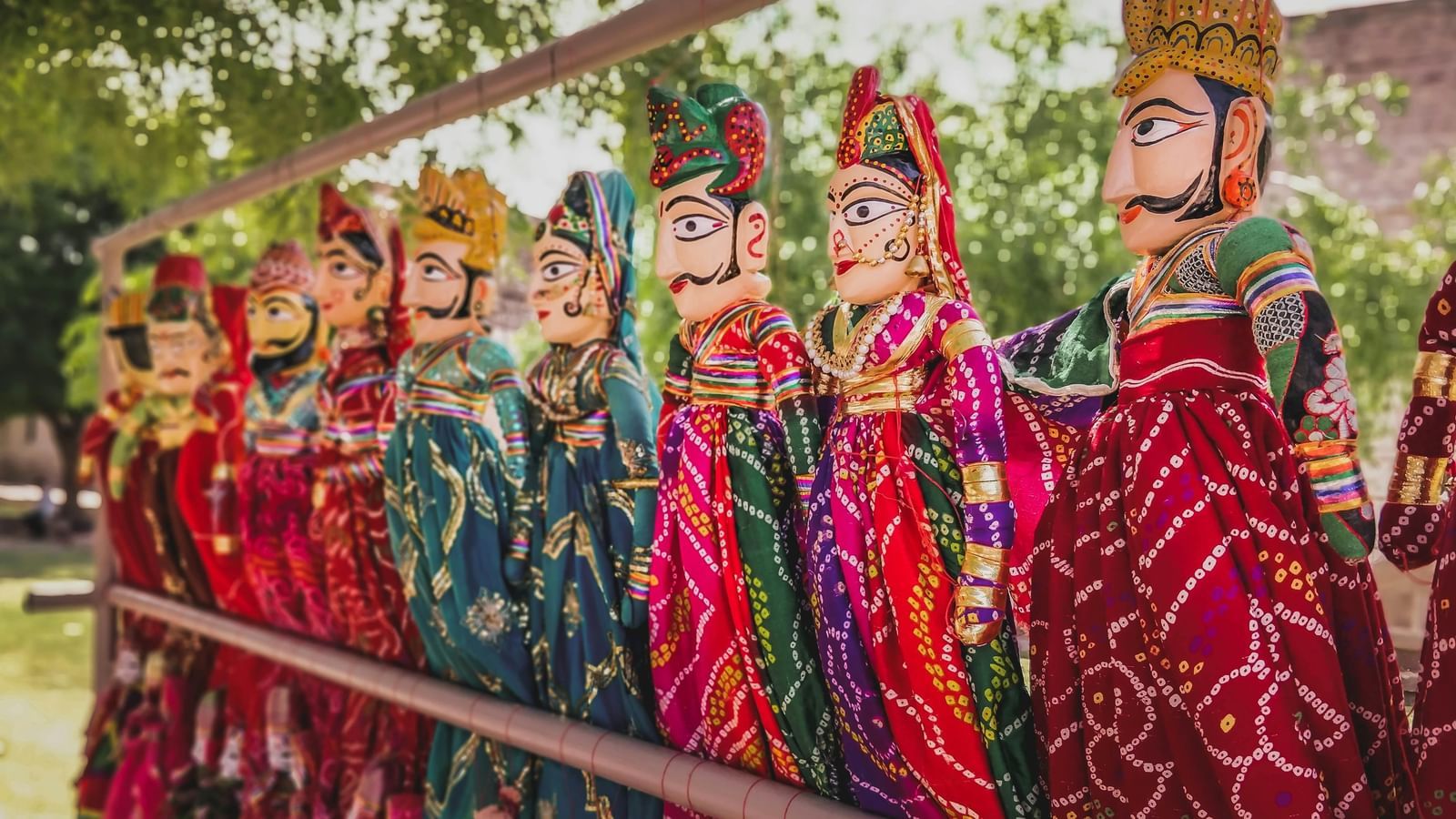 An image of a puppet show with vibrant rajasthani dolls