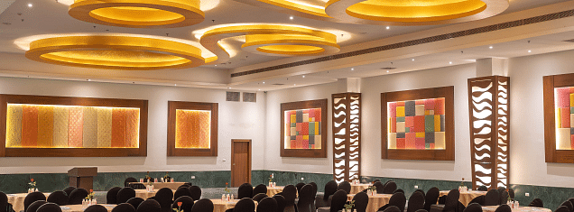 A banquet hall with tables and chairs set for an event. - Bamboo Saa Resort & Spa, Udaipur.