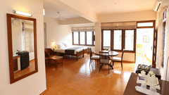 A spacious interior with seating, large windows, and open floor space.